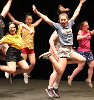 Queen's High School Dance - Queen's girls enthusiastically leaping into the air